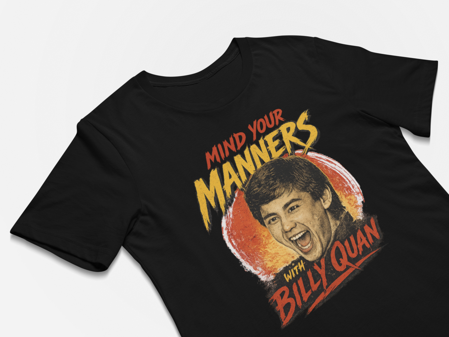Black t-shirt with a graphic of a man's face and text 'Mind your manners with Billy Quan' on a white background