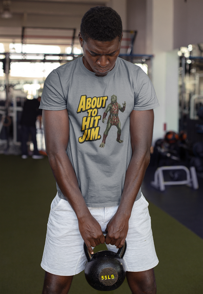 Person lifting a kettlebell wearing a t-shirt with graphic design in a gym setting