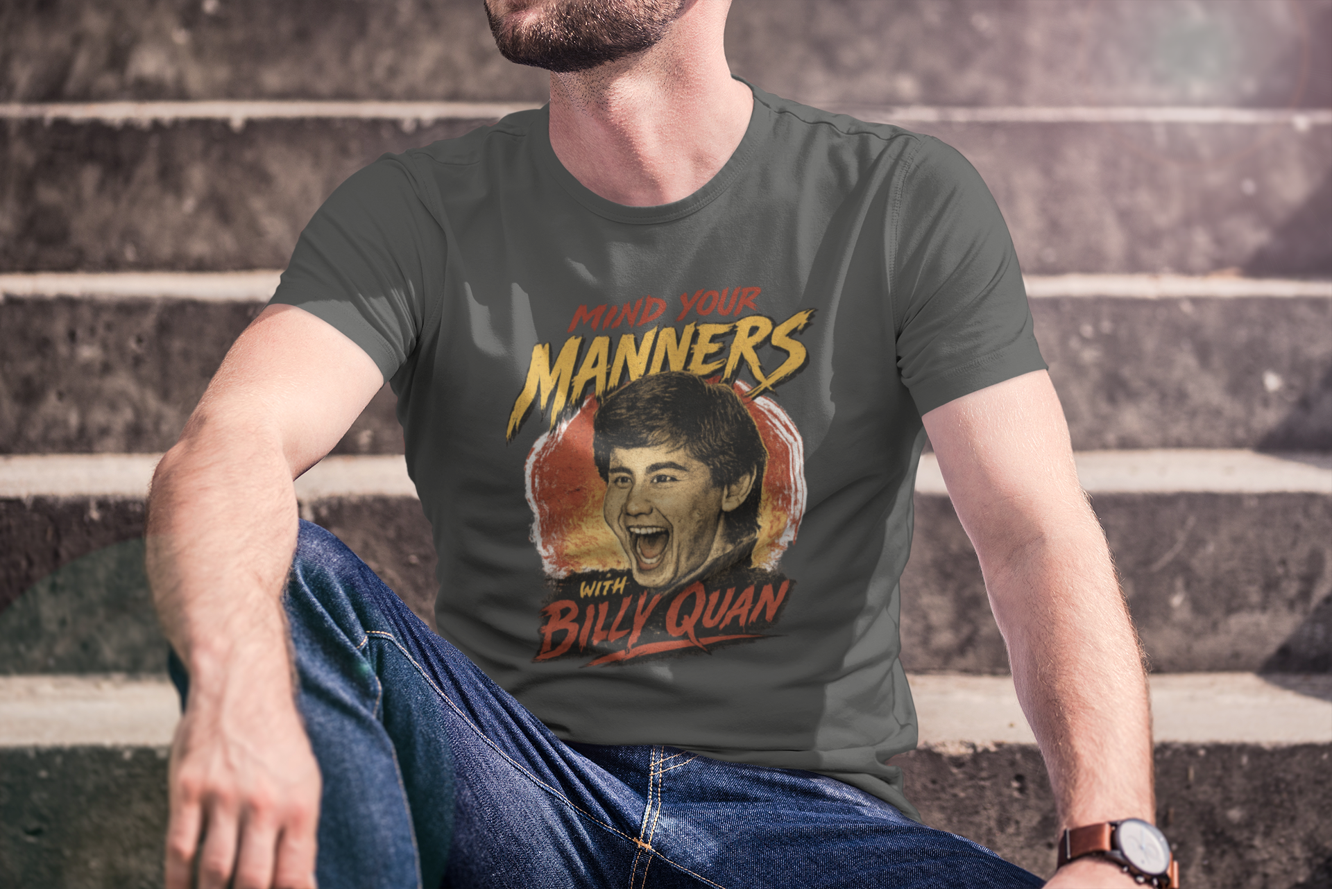 Person wearing a t-shirt with 'Manners with Billy Quan' graphic design.