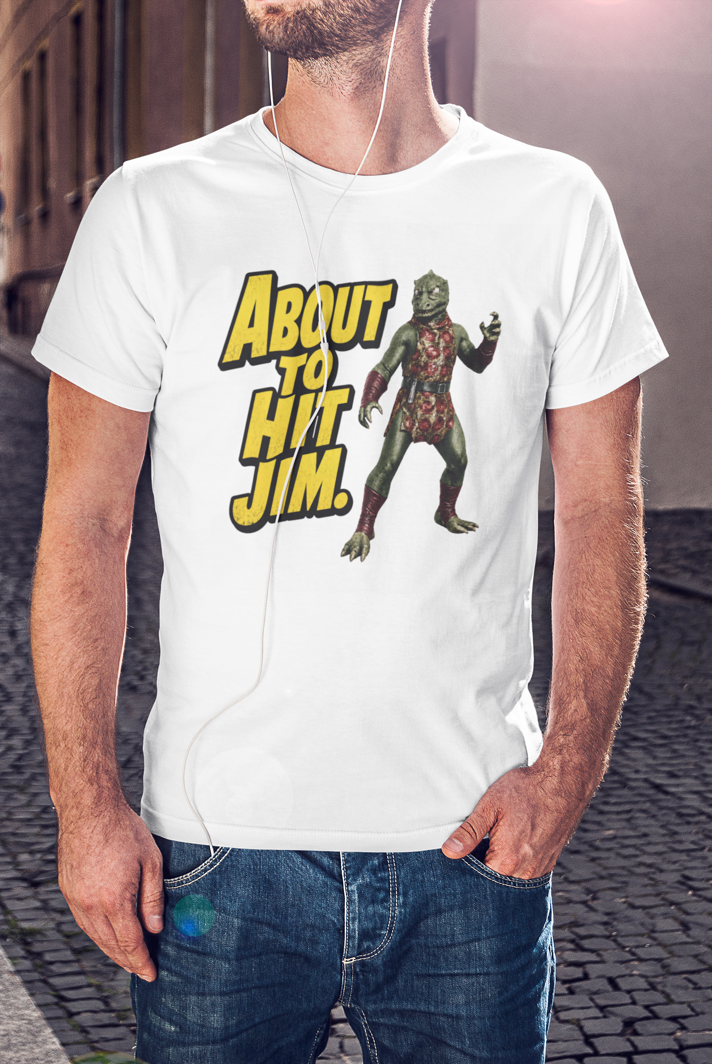 Person wearing a white t-shirt with a graphic design and text 'About to Hit Jim' on a street.